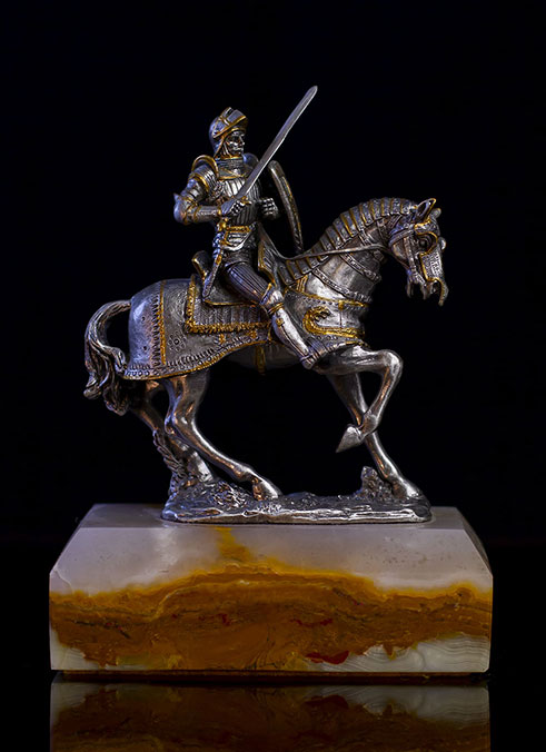 photo of a knight statue against a black background