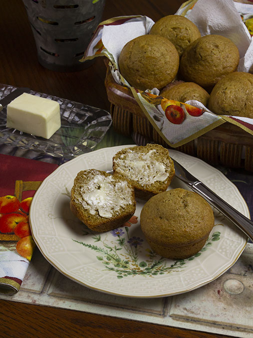 photo of a plate with buttered muffins on it